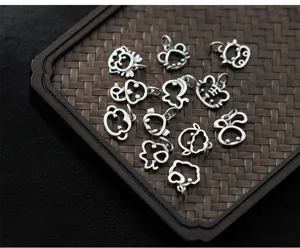 Macro view of S925 silver hollow-out zodiac animal charms for handmade DIY jewelry