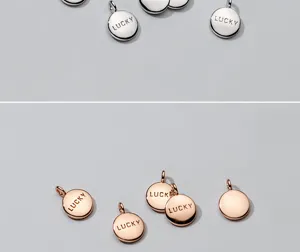 Detailed view of silver and rose gold S925 plated round charms with LUCKY engraving