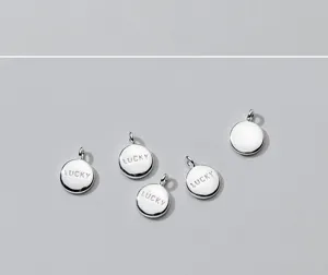 Detailed view of polished S925 silver plated round lucky pendants for DIY jewelry.