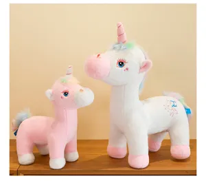 Detailed shot of white and pink plush unicorn toys with colorful rainbow manes and tails