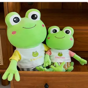 Close-up of cute green frog plush toys in two sizes with Emotion print shirts