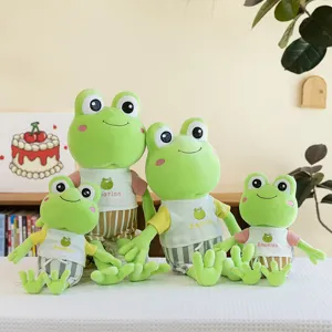Set of four cute green frog plush toys wearing colorful t-shirts and striped shorts