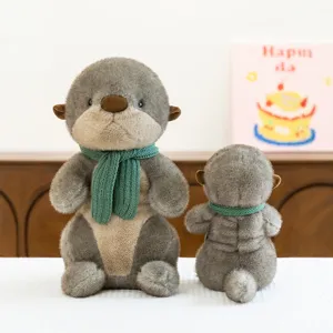 Adorable gray otter plush toys wearing green knitted scarves in a cozy indoor setting