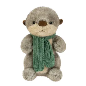 Adorable grey otter plush toy wearing a green knitted scarf, soft stuffed animal doll