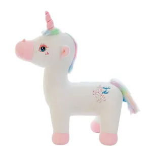 Soft white unicorn plush toy with rainbow mane and tail, featuring pink horn and hooves