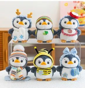 Variety of cute penguin plush keychains with colorful hats and scarves in a group display