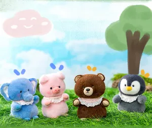 Cute group of small plush toys: elephant, pig, bear, and penguin on vibrant green grass