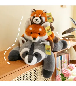 Macro view of soft red panda and raccoon plush toys stacked in a cozy home setting