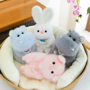 Set of four cute plush animal pendants in a basket including a rabbit and a pig