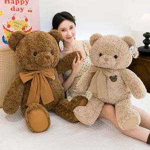 Morbido orsetto di peluche con fiocco in marrone e beige, decorazione accogliente