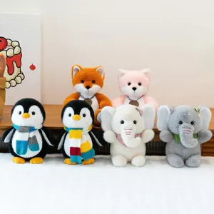 Cute plush toy set featuring penguins with scarves, foxes, and elephants on a bed.
