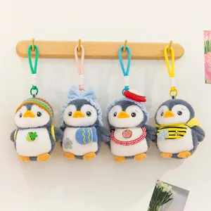 Set of four cute plush penguin keychains featuring colorful hats and lovely accessories