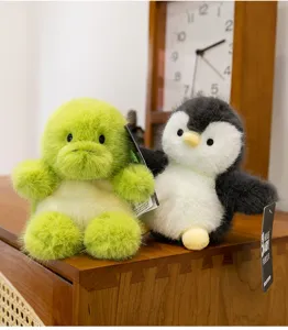 Detailed close-up showing the soft fluffy texture of the penguin and turtle plush toys