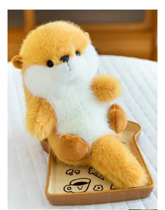 Close-up of fluffy orange and white plush toy sitting on a bread-shaped plate