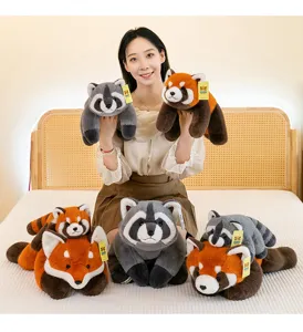 Smiling Asian model presenting cute red panda and raccoon plush toys on a cozy bed