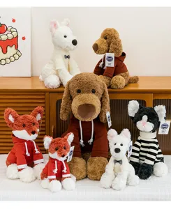 Group of cute plush dogs and foxes wearing colorful hoodies and sweaters on a table