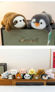 A diverse collection of small, cute palm-sized animal plush toys in soft textures