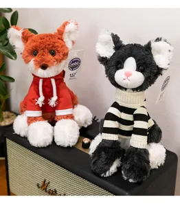 Macro view of creative plush fox and dog toys wearing colorful knitted sweaters and hoodies