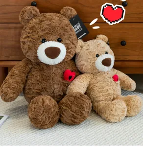 Close-up detail of dark and light brown rose-swirl plush teddy bears with heart embroidery