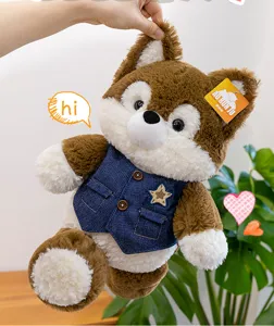 Detail view of a soft fluffy husky plush toy wearing a blue denim vest with a star.