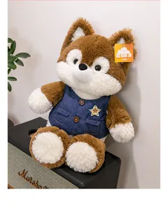 Detail of a plush fox toy wearing a blue denim vest with a star patch on a speaker