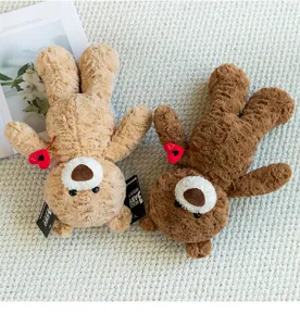 Macro view showing the rose petal texture and brand tags of the two teddy bears.
