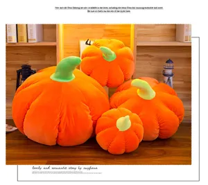 Detailed view of four orange pumpkin plush toys in various sizes on a wooden shelf