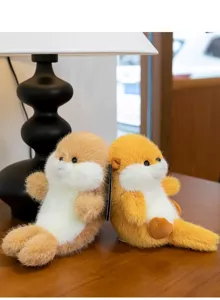 Close-up of two fluffy otter plush toys in brown and yellow on a wooden table