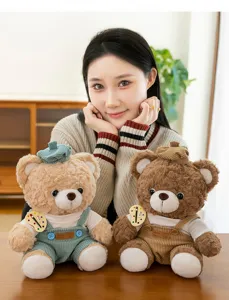 Detail of teddy bear plush toy wearing corduroy overalls and artist beret