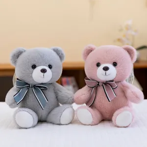 Pair of cute plush teddy bears featuring elegant ribbon bow ties in grey and pink soft fur