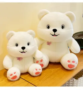 Two cute white plush bears with butterfly bowties sitting on a wooden surface.