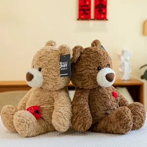 Pair of cute teddy bear plush toys with heart decorations in cozy home setting