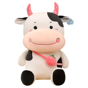 Adorable cartoon cow plush toy featuring a cute strawberry bag and soft pink horns