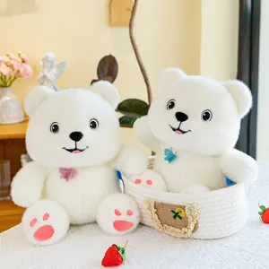 Pair of cute white butterfly bear plush toys displayed in a decorative woven basket