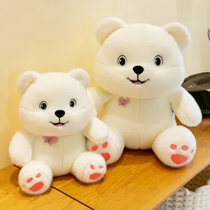 Cute white plush bear toys with glitter butterfly accents presented on a wooden table