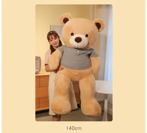 Large 140cm giant teddy bear plush toy with grey knitted sweater held by a girl