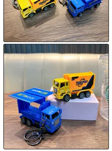 Close-up of mini alloy truck keychains in blue and yellow with openable containers