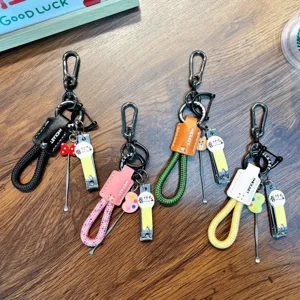 Set of 4 colorful braided rope keychains with nail clippers and ear picks on wood surface.