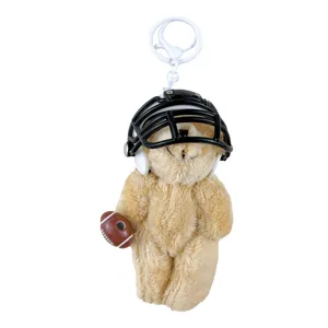 Cute plush teddy bear keychain wearing a black football helmet and holding a brown ball