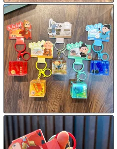 Collection de porte-clés colorés en forme de bouteille de sable mouvant à l'huile