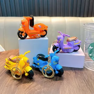 Set of four colorful inertial toy motorcycle keychains with retro scooter design for kids