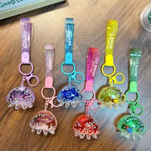 Cute acrylic jellyfish liquid glitter shaker keychain with 'Just Keep Doing It' wrist strap