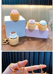 Detailed view of cute steamed bun keychains with light-up feature and golden rings