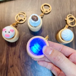 Glowing steamed bun stress relief keychain with cute cartoon pig and traditional designs