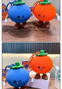 Detail view of cute blue and orange silicone fruit coin purse keychain charms
