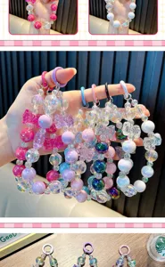 Close-up of colorful beaded phone straps with iridescent crystals and bows