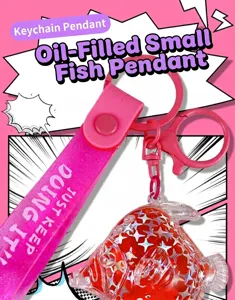 Close-up of pink liquid oil fish keychain featuring a glitter strap and fish charm