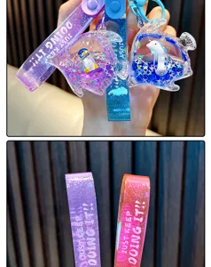 Close-up of glitter strap and liquid-filled fish keychain with penguin and dolphin