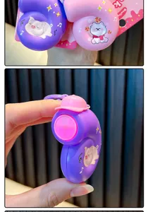 Close-up detail of a purple snail-shaped music stress relief toy keychain with pig cartoon