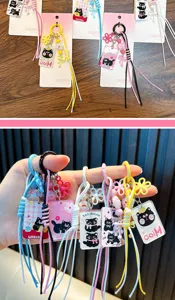 Detailed view of colorful cartoon cat keychains with braided ropes and flower charms